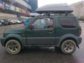 Suzuki Jimny - with roof box Thule Pacific 200 - B01.jpg