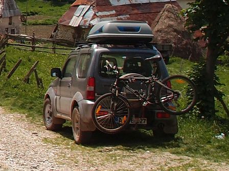 Suzuki Jimny with a bicycle carrier for two bikes on a tow hook, with one bike - A01.jpg